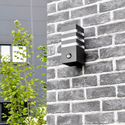 Zewnętrzna lampa ścienna z czujnikiem TEKSAS 1xE27/12W/230V IP44 antracyt